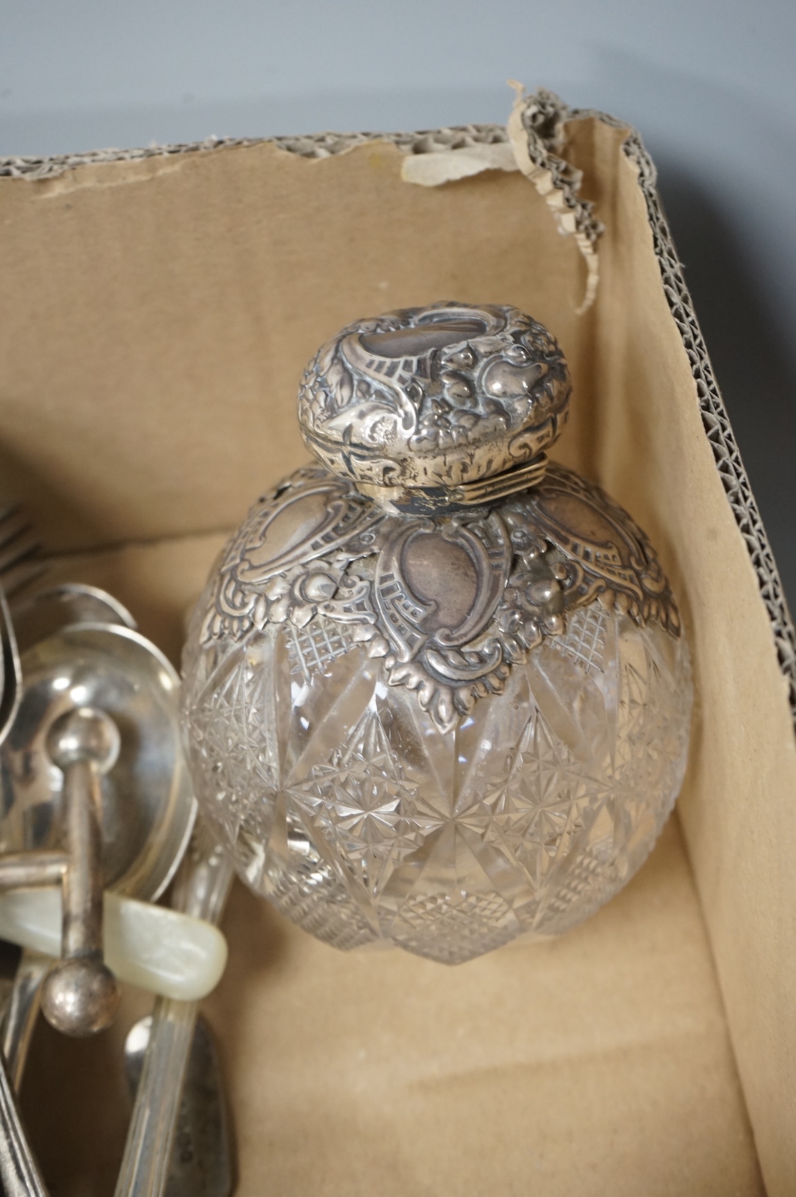 A pair of Victorian silver King's pattern table spoons by George Adams, London, 1858, a silver teaspoon, a mounted glass scent bottle, a silver cigarette case, a continental canister with inset coin lid, and assorted pla